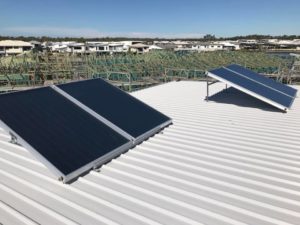 Solar hot water system panels installed on a metal roof in Noosa