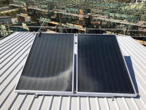 Solar hot water panels fitted to a metal roof in Noosa, forming part of an energy-efficient hot water system