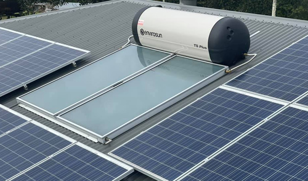 Solar hot water system on a metal roof with PV panels in Noosa